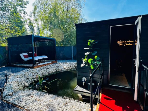 Cruiser Entrance with neon sign and outdoor cinema day bed