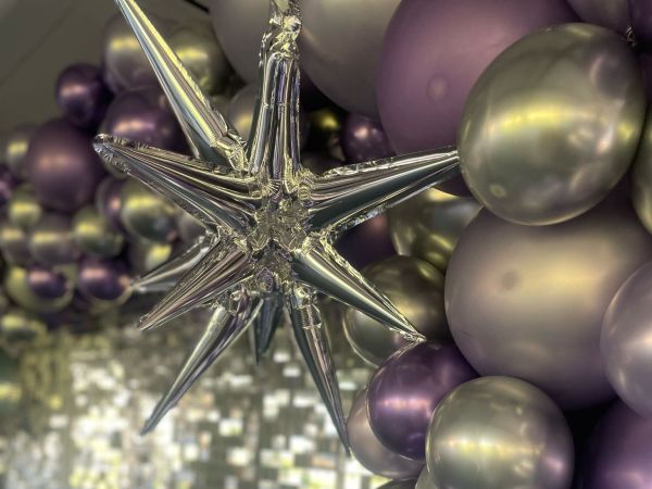 Themed feature wall with balloon garland and star balloons
