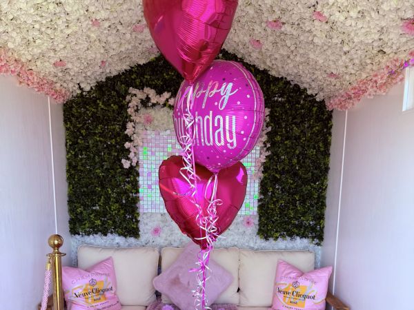 Pink Hut interior with celebration balloons