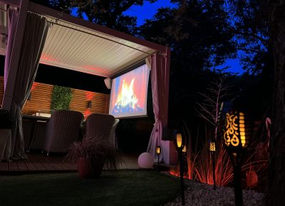 The Copper Crib garden at dusk - featuring the outdoor screen