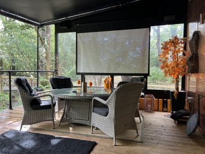 The Copper Cabin Exterior table with screen