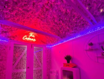 The Cabana Interior with Neon Sign and Flower Ceiling