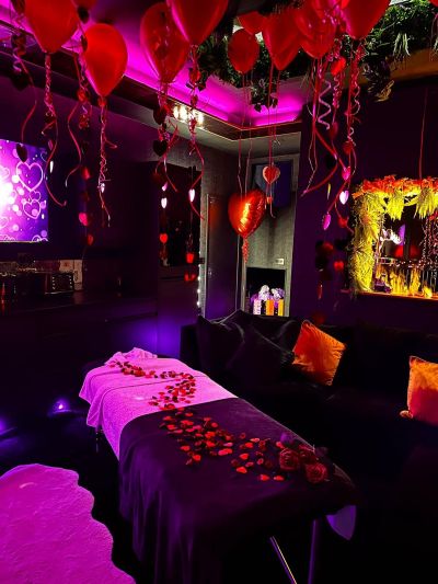 The Crib set up for a massage with ceiling balloons and love heart balloon
